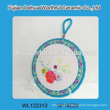 Flower design ceramic pot mat with blue rope